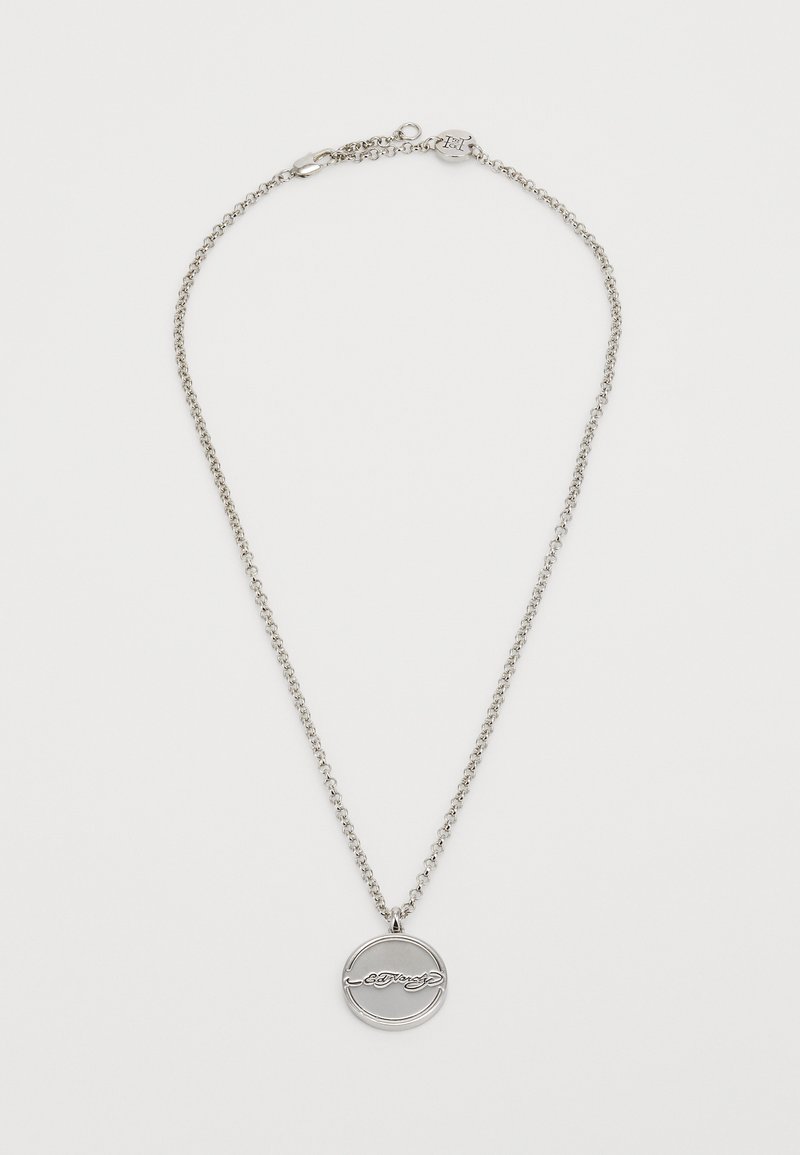 Silver pendant necklace with a round charm featuring a cursive inscription. The chain has a simple, linked design and clasp closure.