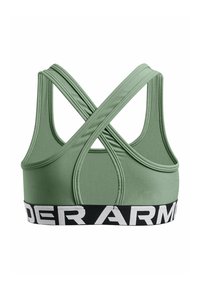 Zelena športna modrc s križnim dizajnom, izdelana iz gladkega materiala. Ima širok črn pas z belim logotipom "UNDER ARMOUR".