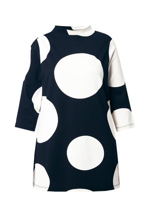Tuniek met lange mouwen in marineblauw met grote witte stippen. Voorzien van een col en zijsplitten voor bewegingsvrijheid. Glad, rekbaar materiaal.