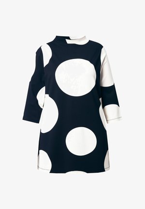 Laivastonsininen pitkähiha tunika, jossa on suuret valkoiset pilkut. Varustettu puolikorkealla kauluksella ja sivuhalkioilla liikkumisen helpottamiseksi. Sileä, joustava kangas.