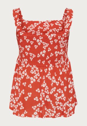 Red floral top with smocked bodice and ruffled straps. Features white flower pattern and pleated skirt section, made from lightweight fabric.