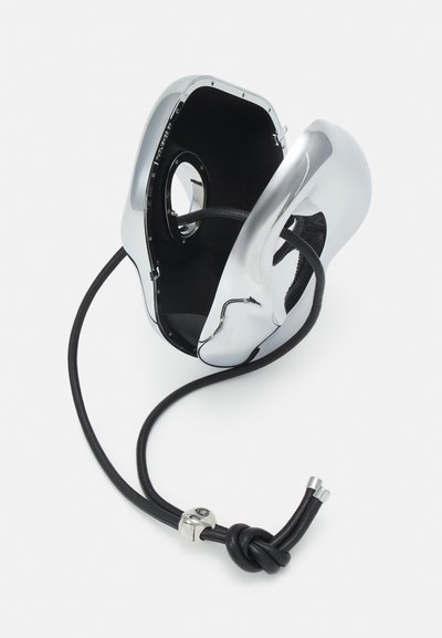 Chromed accessory holder with a sleek, rounded design. Features a black interior, a textured black cord, and silver hardware details.