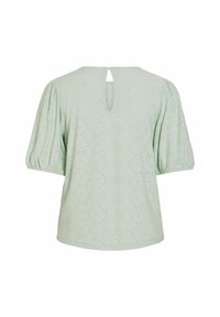 Blusa verde chiaro con maniche a sbuffo, caratterizzata da una schiena a chiave e un motivo ad occhiello su tutta la stoffa per aggiungere texture e dettagli.