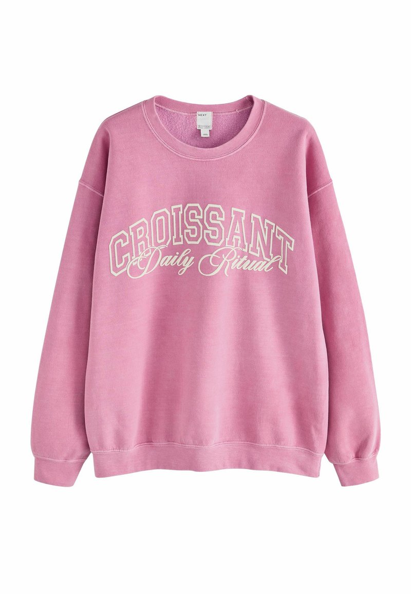 Pink sweatshirt with a crew neck, long sleeves, and white "CROISSANT Daily Ritual" text. Features a soft texture and casual fit.
