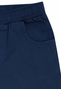 Marineblaue Baumwollhosen mit elastischem Taillenbund, einer Seitentasche und einem glatten, strukturierten Stoff. Minimalistisches Design ohne Muster.