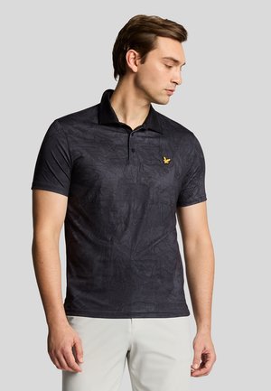 Black polo shirt with a subtle textured pattern, featuring a black collar and a small gold logo on the chest. Short sleeves.