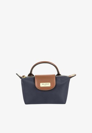 Petit sac à main bleu marine avec poignée et rabat en cuir marron, fermeture éclair dorée et plaque de marque Ted Lapidus Paris dorée à l'avant.