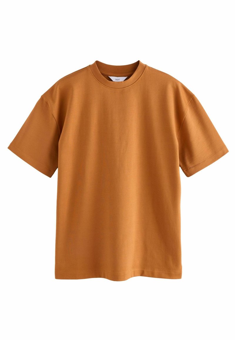 T-shirt z krótkim rękawem w kolorze palonej pomarańczy, wykonany z bawełny, z okrągłym dekoltem i luźnym krojem. Gładka faktura, bez widocznych wzorów czy akcentów.