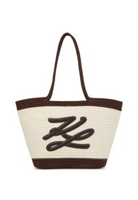 Austo aušanas salmu soma ar brūniem akcentiem, ar drosmīgu, teksturētu logo dizainu krēmkrāsas pamatē un divām izturīgām rokturiem.