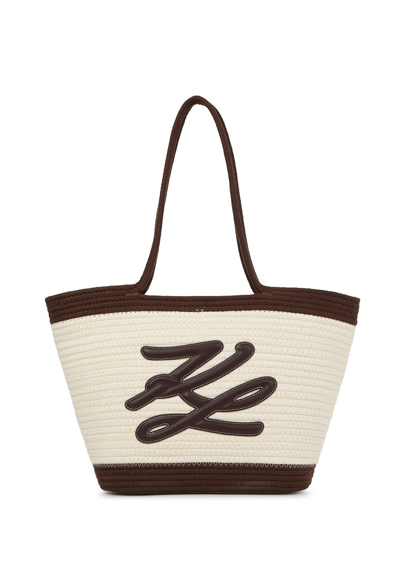 Austo aušanas salmu soma ar brūniem akcentiem, ar drosmīgu, teksturētu logo dizainu krēmkrāsas pamatē un divām izturīgām rokturiem.