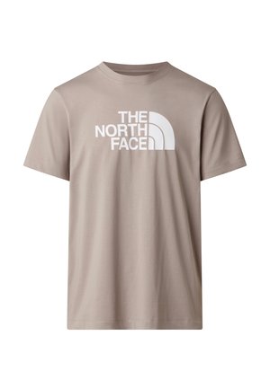 Beige kortærmet T-shirt lavet af bomuld, med et stort hvidt logo af "The North Face" på forsiden. Enkel og klassisk design.
