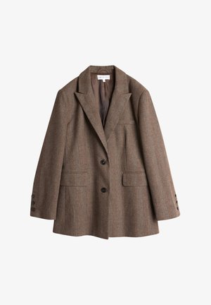 Brun rutete blazer med notklipper, en-knappslukking og to frontlommer. Har en glatt innerfôr og dekorative knapper på ermene.
