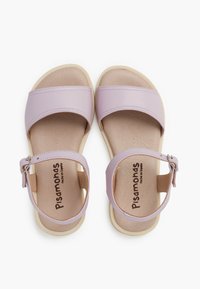 Lilac sandals with wide straps, ankle buckle, cushioned insole, and textured beige sole. Features a smooth matte finish.