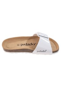 Sandal blanca de slide con una plantilla de corcho y ante, que cuenta con una correa ajustable con hebilla y suela texturizada. Nombre de la marca grabado en el interior.