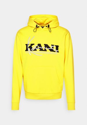 Felpa gialla con logo "KANI" in bianco e nero sul petto. Caratterizzata da una tasca frontale, cappuccio con coulisse e polsini a costine.