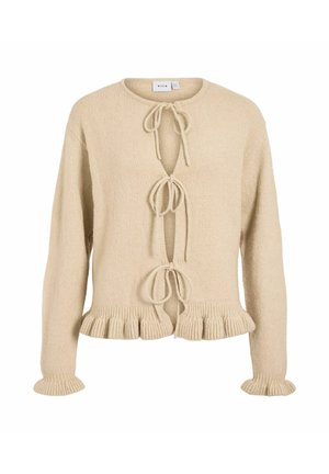 Beige knitted cardigan with long sleeves, tie closures at the front, and a ruffled hem and sleeve cuffs. Soft texture, casual design.