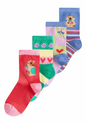 Four colorful children’s socks with animal, heart, butterfly, and ladybug patterns arranged in a diagonal line on a white background.