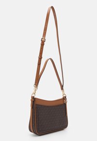 Brązowa torebka na ramię z regulowanym paskiem. Posiada charakterystyczny wzór, gładkie skórzane akcenty i złote elementy z boku.