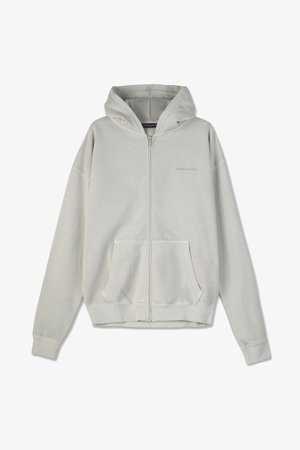 Lys grå hettejakke med glidelås laget av mykt stoff, med en frontlomme, hette og ribbestrikkede mansjetter. Enkelt design med minimal detaljering.