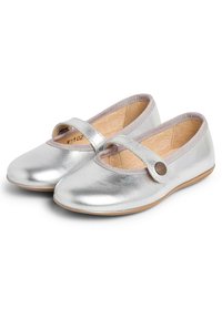 Silver leather Mary Jane shoes with a rounded toe, ankle strap, and a textured insole. Trimmed with contrasting fabric at the opening.