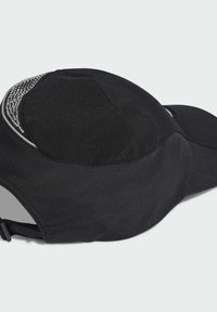 Čierny športový šiltovka s hladkou textíliou, zaobleným tvarom, reflexnými akcentmi a perlovým detailom pozdĺž horného okraja. Nastaviteľný popruh na zadnej strane.