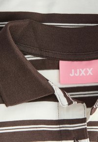 Brown and cream striped polo shirt with a ribbed collar, featuring a pink label that reads "JJXX" on the back neck area.