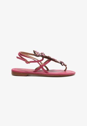 Pink flat sandal with wooden sole, thin straps, ankle buckle, and decorated with pink and clear jeweled embellishments on the upper strap.