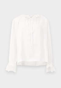 Blouse blanche à manches longues en tissu lisse, avec un col rond, une fermeture à boutons et des poignets ornés de dentelle. Se fixe avec un lien au cou.