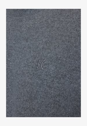 Gray fabric with subtle embroidered "EC" initials in matching thread centered on the material.