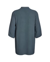 Tunika dugih rukava bez dugmadi u teksturiranom, tamno tirkiznom materijalu; ima okrugli izrez i pada labavo ispod bokova.