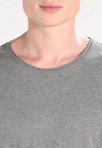 Gray short-sleeve T-shirt with a round neckline. Made from a soft, smooth fabric. Features a subtle heathered texture.