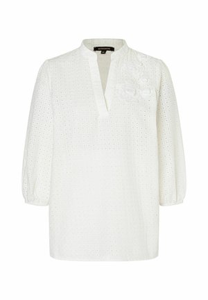 Weiße Bluse mit V-Ausschnitt, puffigen Ärmeln und gestickten floralen Details. Aus strukturiertem Stoff mit Lochmuster gefertigt.