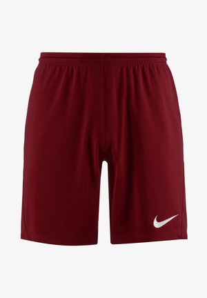 Red athletic shorts with an elastic waistband, made of smooth fabric, featuring a white Nike logo on the lower right leg.