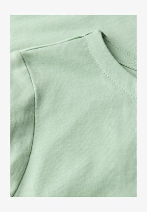 Ljusgrön bomull T-shirt med ribbat mönster, med rundad halsringning och korta ärmar. Snygga sömnadsdetaljer är synliga.