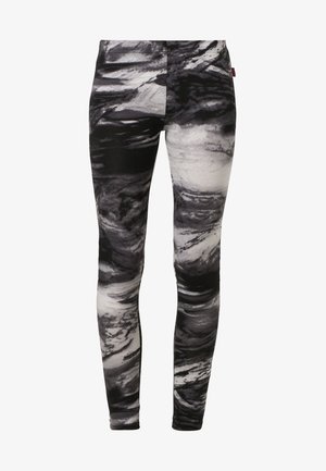 Leggings ajustés à motif marbré noir et blanc, taille haute et jambes longues.
