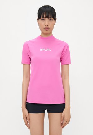Short-sleeve, fitted pink rash guard made of stretchy material, featuring a high collar and white "RIP CURL" logo on the front.
