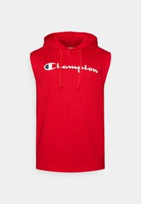 Red sleeveless hoodie made of cotton, featuring a front pocket, drawstrings, and a large white "Champion" logo across the chest.