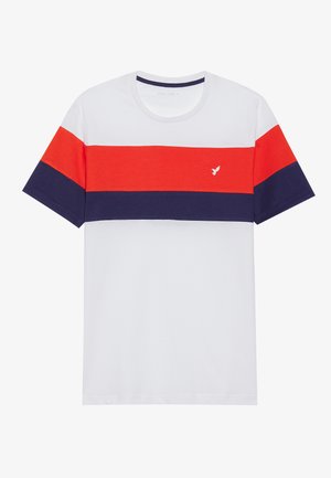 T-shirt en coton avec des rayures horizontales rouges, bleu marine et blanches ; col rond ; petit logo d'oiseau sur la poitrine.