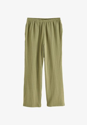 Zelené široké nohavice s elastickým pásom. Majú vertikálne pruhy a mäkkú textúru. Bez vreciek alebo ozdobných akcentov.