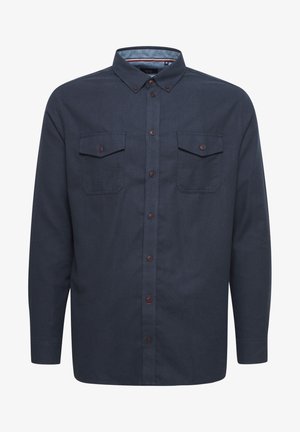 Tummansininen nappikauluspaita, joka on valmistettu sileästä kankaasta ja jossa on kaksi rintataskua ja ruskeat napit edessä.