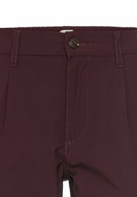 Burgundihosen mit einem Knopfverschluss, flachem Vorderteil und Fronttaschen. Kh smoothes Material mit kontrastierenden Nähten.
