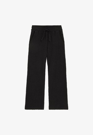 Pantaloni largi negri cu textură, talie elastică și șnur, cu buzunare laterale, așezați pe o suprafață albă.