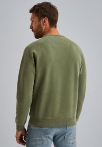 Olive green sweatshirt with a crew neckline, ribbed cuffs, and hem. Made of soft material with a smooth texture and simple design.