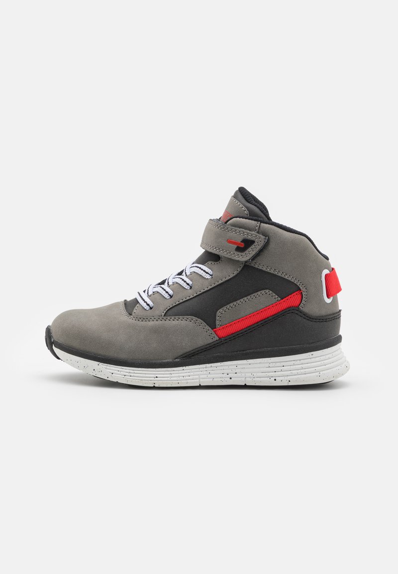 Gray suede high-top sneaker with black accents, red strap detail, white laces, and a speckled white sole. Features velcro strap for closure.