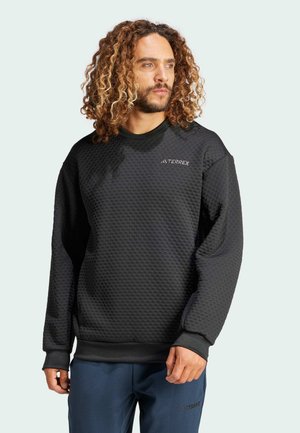 Black, textured sweatshirt with a honeycomb pattern, featuring a round neck and long sleeves. Includes a small logo on the chest.