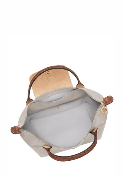 Gray leather handbag with brown textured handles, a spacious interior, zippered pocket, and snap closure. Accented with gold hardware details.