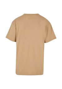 Tricou cu mânecă scurtă din bumbac bej, cu guler rotund și croială lejeră. Fără modele sau accente vizibile.