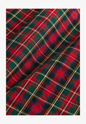 Red and green tartan fabric with intersecting lines in various colors, creating a classic plaid pattern.