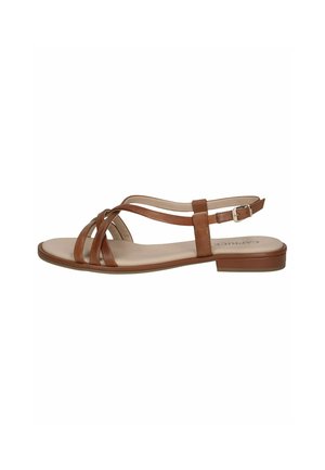 Sandal in pelle marrone con suola piatta, dotata di cinturini incrociati e fibbia alla caviglia per una vestibilità sicura. Texture liscia e elementi di design minimali.