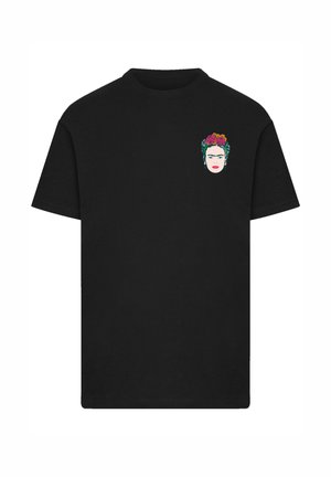 Black short-sleeve T-shirt with a small colorful graphic of a woman's face wearing flowers on her head on the left chest.